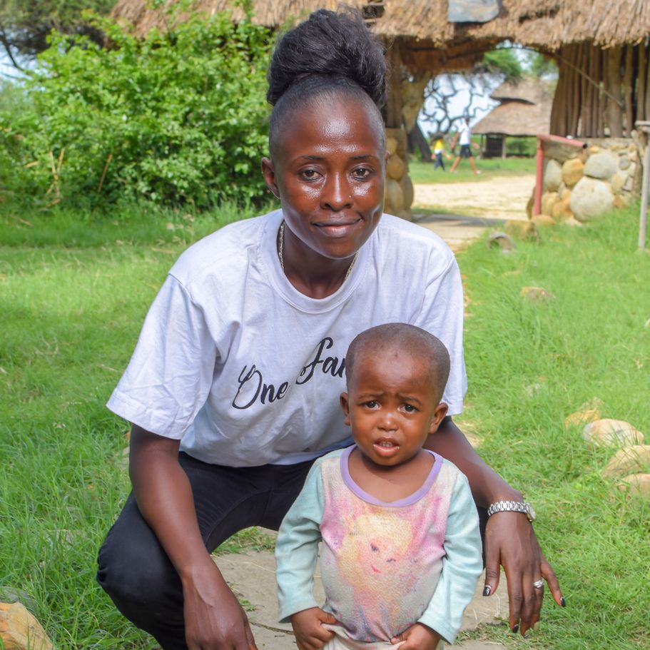 Sada Baja with a child in a grassy landscape